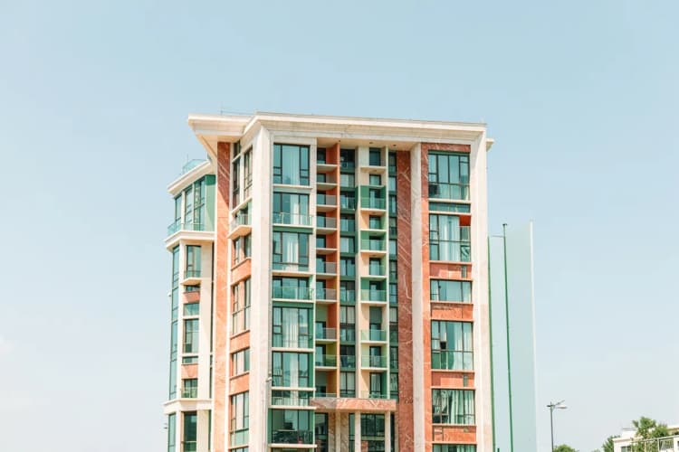 Fachada imponente de um edifício residencial de alto padrão com detalhes em mármore e vidro